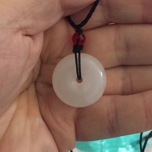 Bi Disk with adjustable neck cord. Good luck charm